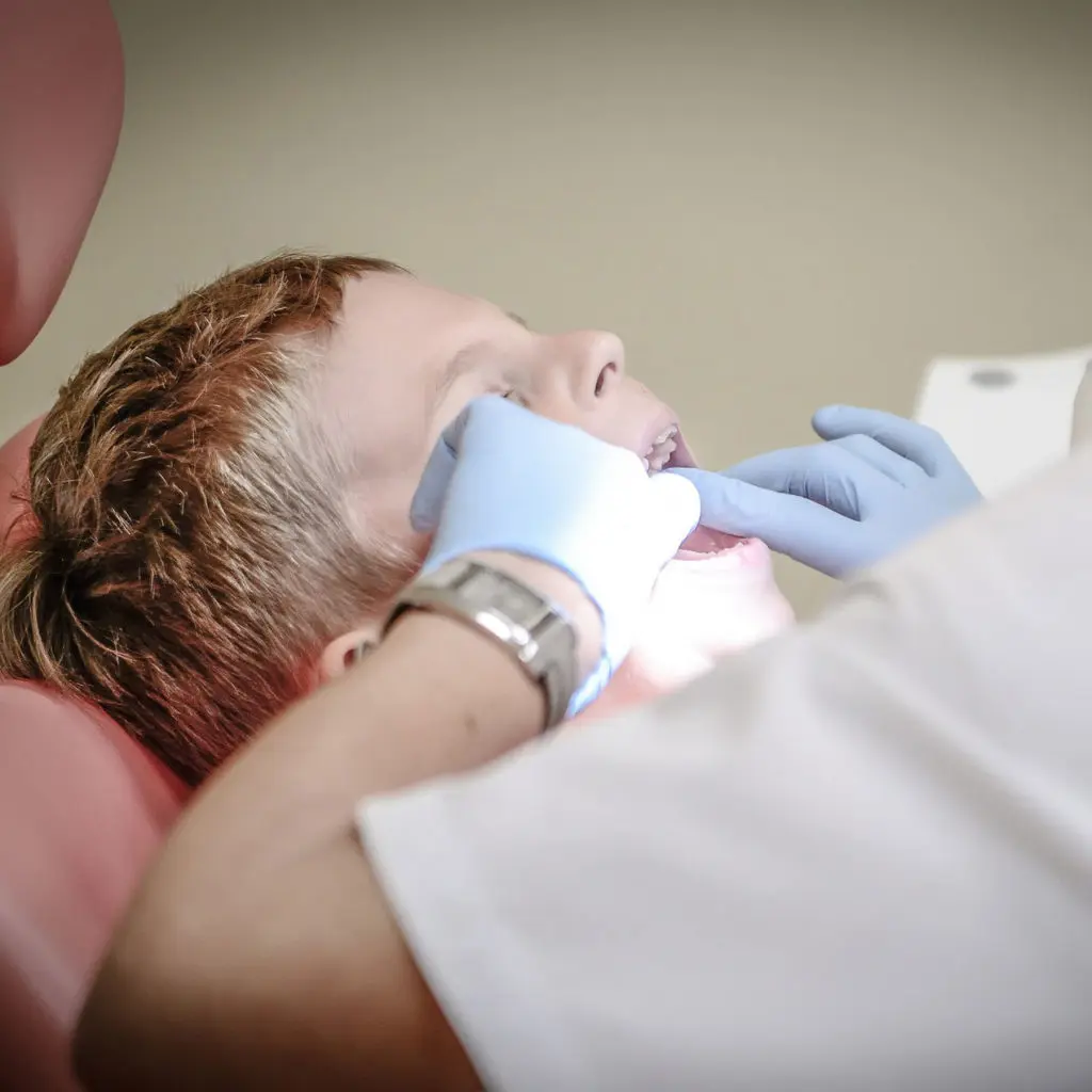 dentist opening a child's mouth