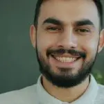 man with a beard and confident smile