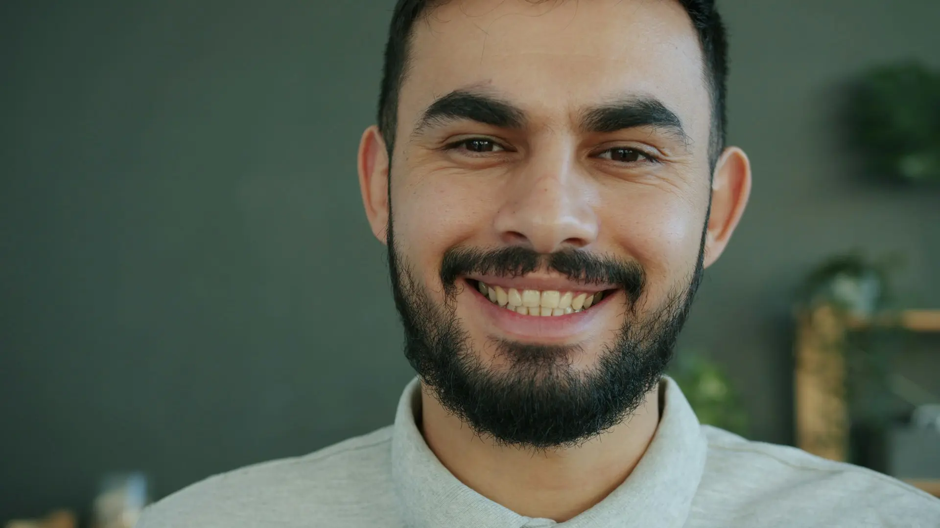 man with a beard and confident smile