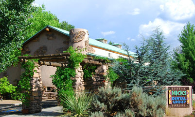 view of Hicks Dental Group building with surrounding plants and trees