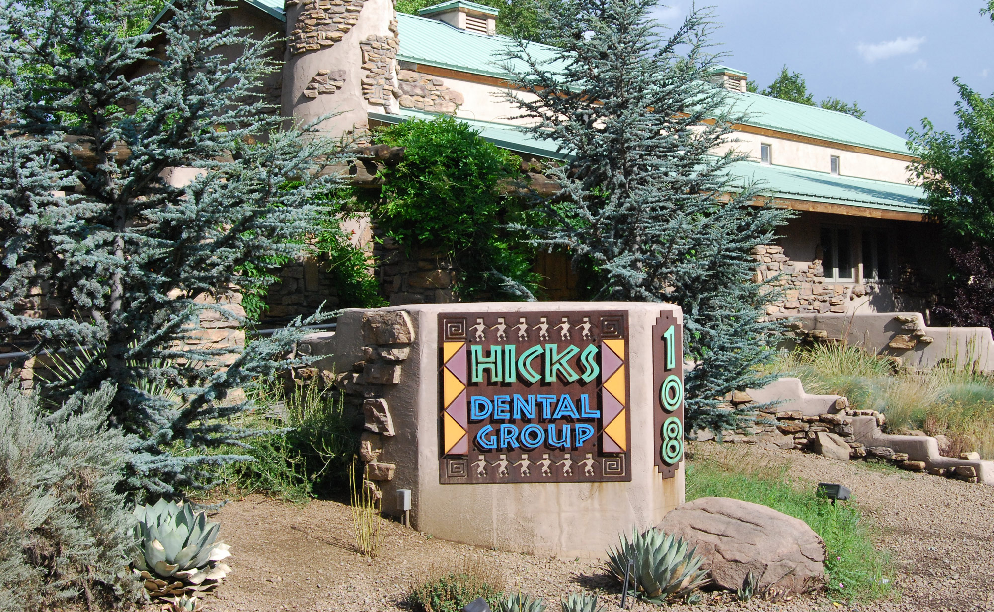 view of Hicks Dental Group building with surrounding plants and trees