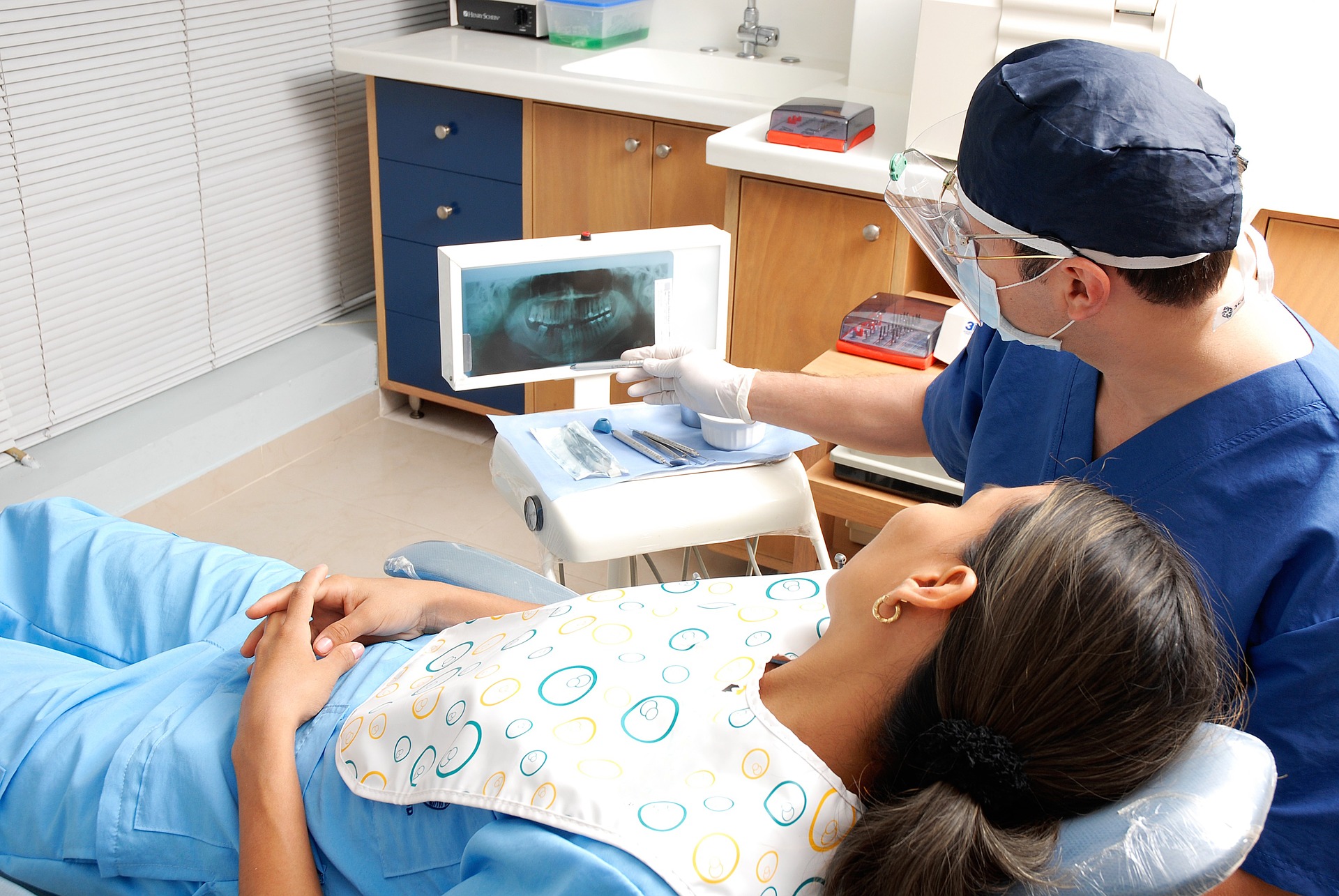 non-surgical gum treatment - dentist showing patient x-ray of teeth