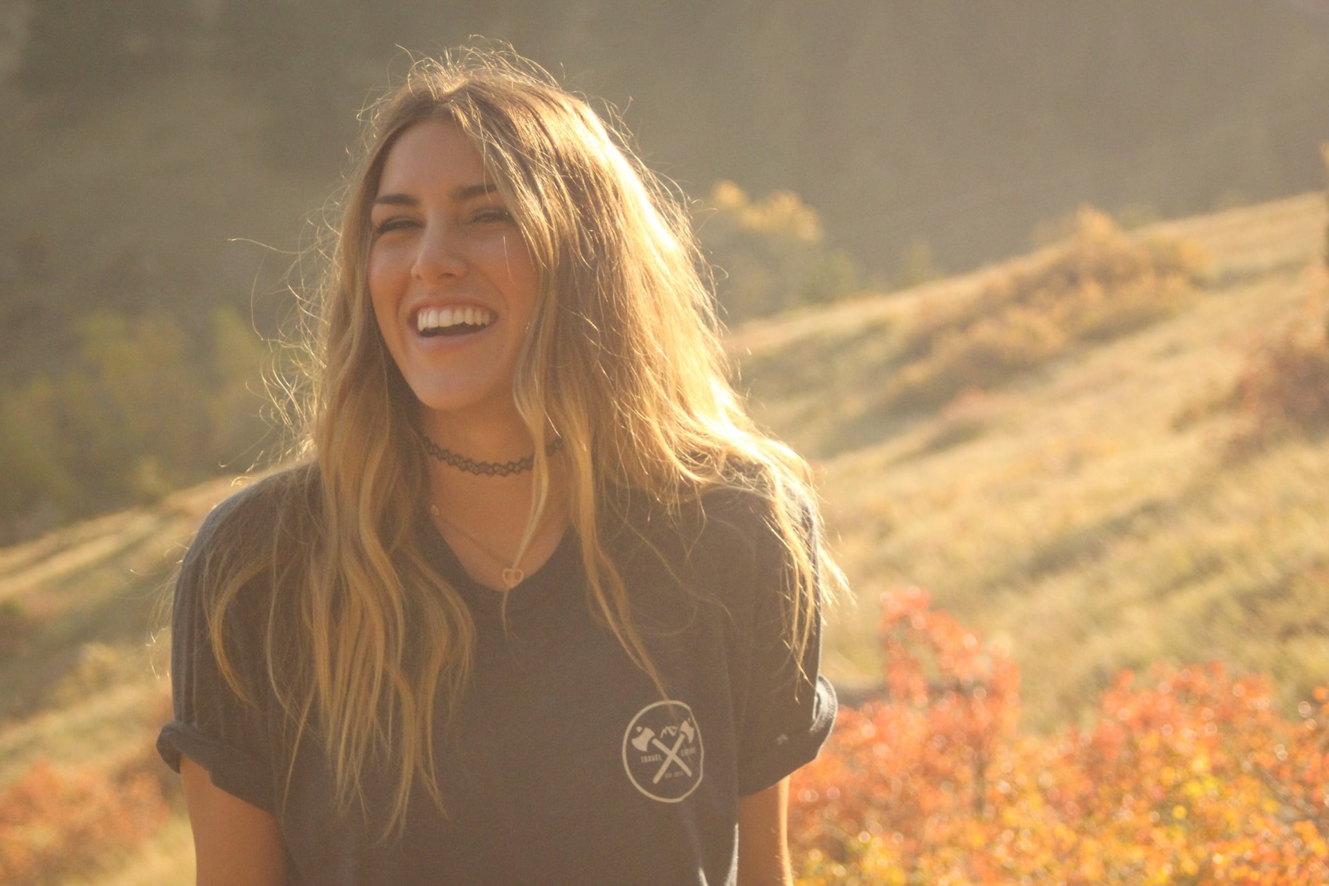 girl smiling in field-gums bleed when brushing