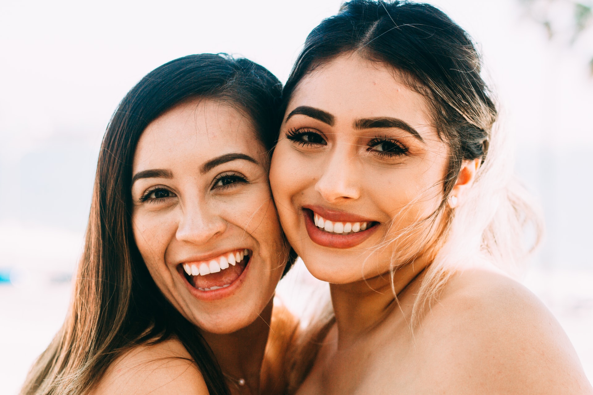 two smiling woman with white teeth - is baking soda safe to whiten teeth
