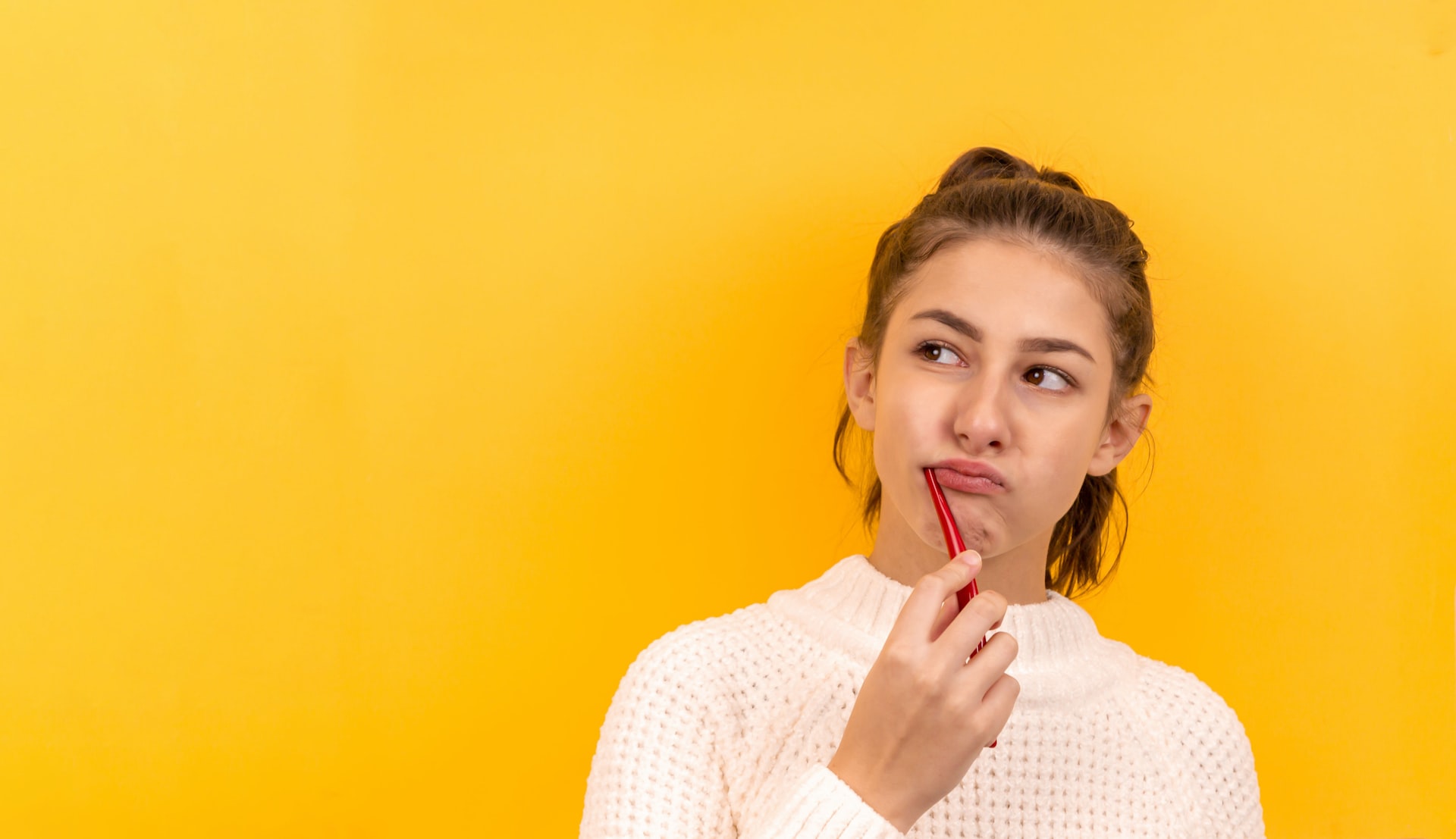 woman bushing her teeth with a red toothbrush - good oral care