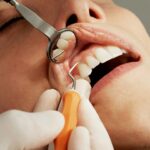 woman getting her teeth scraped - tartar vs. plaque